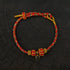 Zenify™ Sutra Light Knot – Handwoven blessing bracelet with red and gold threads and a black gemstone charm.