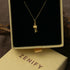 Zenify™ mantra wheel necklace displayed in a gold box, showcasing a prayer wheel pendant on a delicate chain.