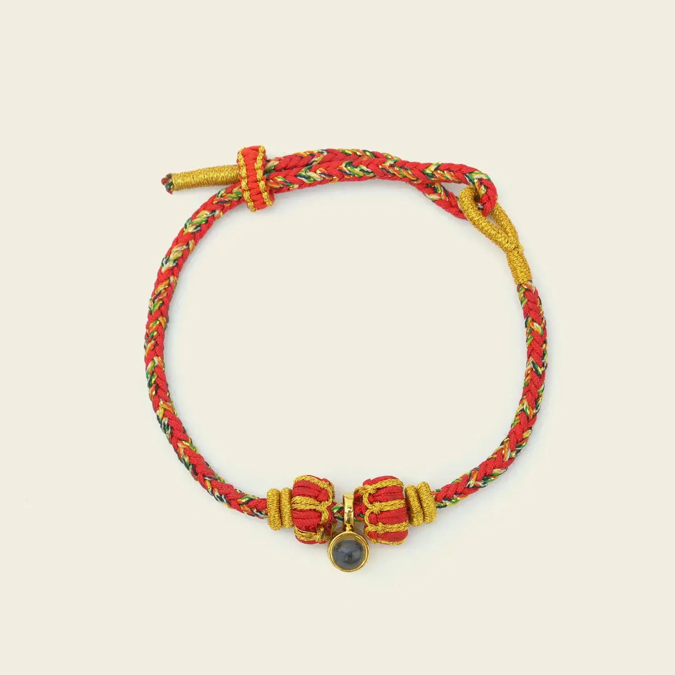 Zenify™ Sutra Light Knot – Handwoven red and yellow blessing bracelet with sacred knot design.