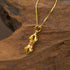 Vajra Pendant Necklace featuring Vajra’s Power symbol, gold design on a wooden background.