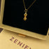 Zenify™ Vajra’s Power necklace with gold pendant featuring pink details, displayed in a gift box.