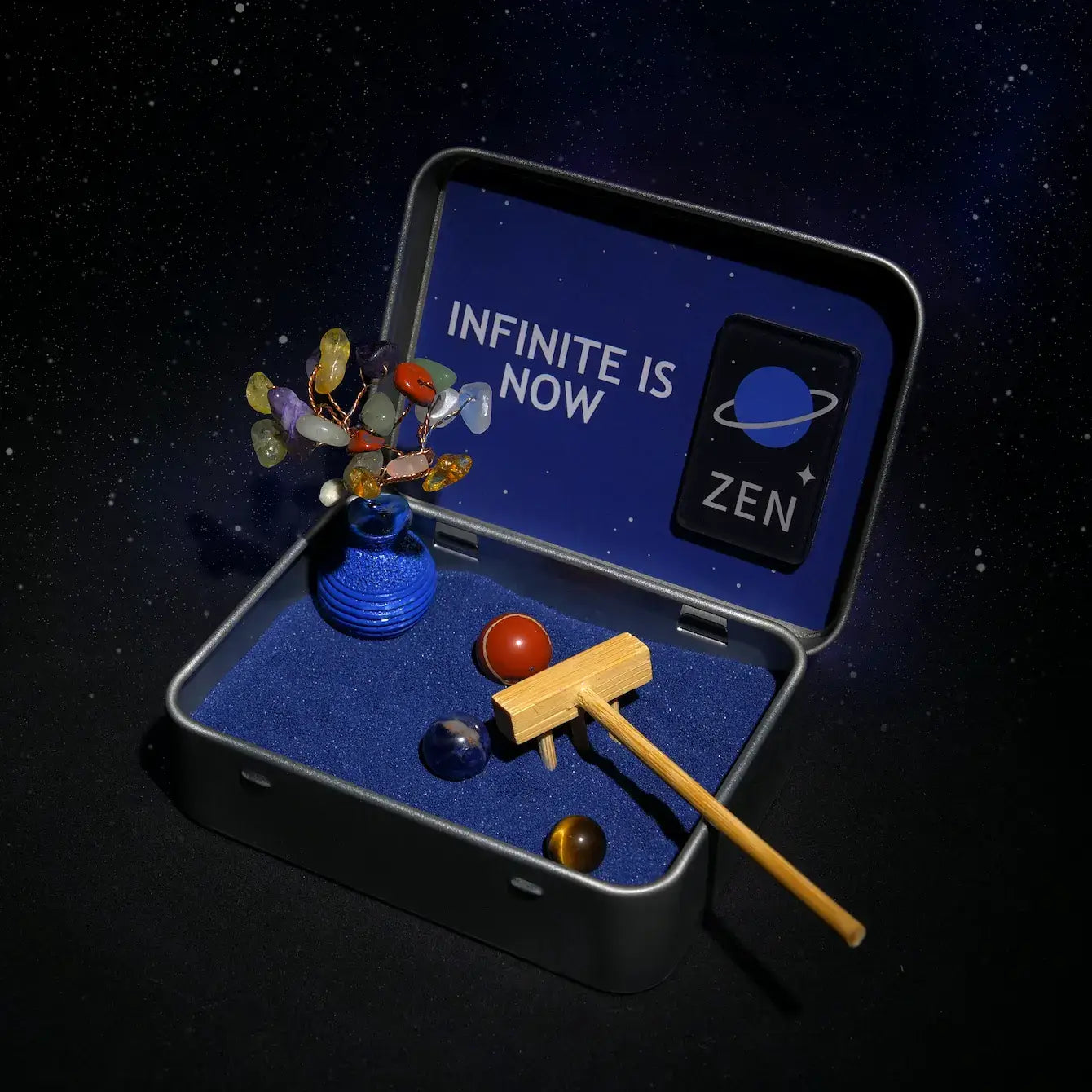 Zenify Cosmic Zen Crystal Garden displayed in a metal box with blue sand, crystal planets, and a wooden mallet.