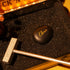Elvis tribute crystal zen garden featuring a black stone with 'Elvis' written in gold on a textured surface.