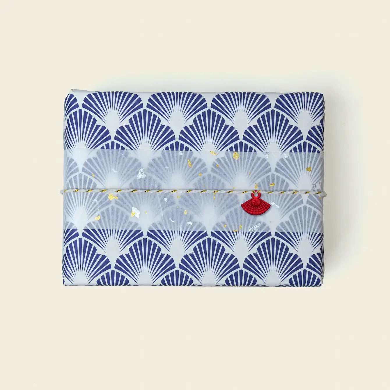 Beautifully wrapped gift with fan design showcasing gift wrapping options for orders.