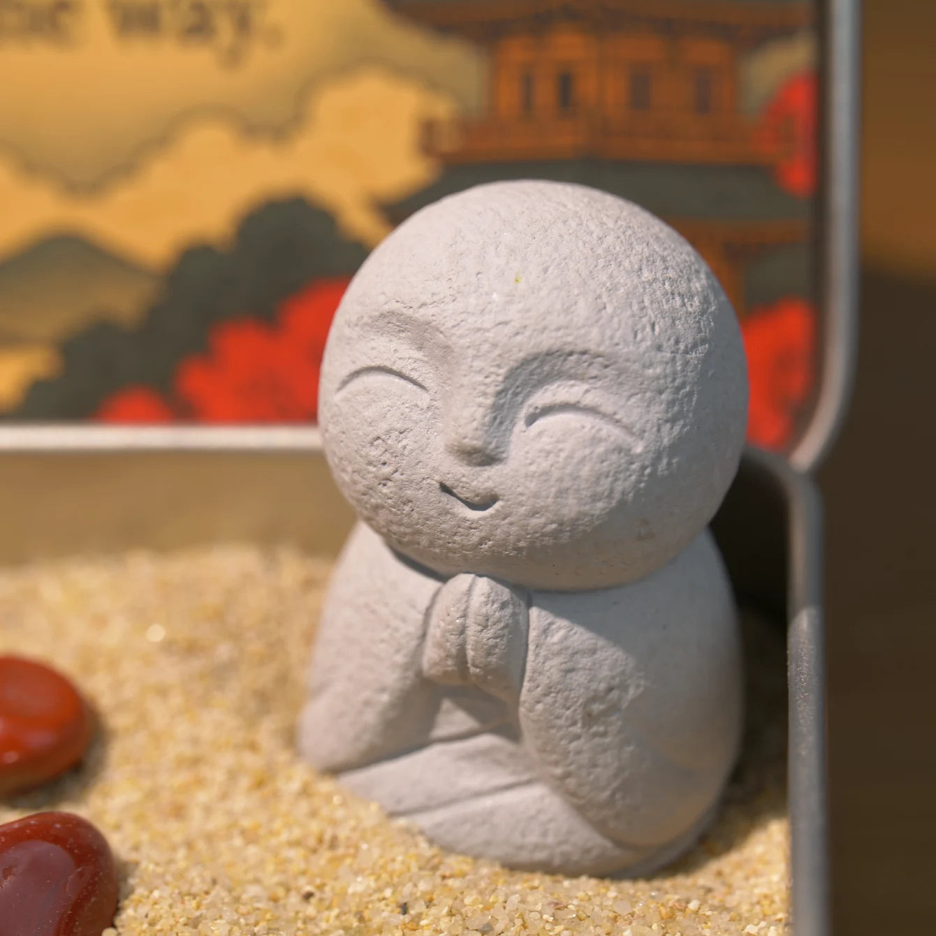 Red Leaf Zen Garden Jizo Buddha statue with natural red jasper crystals in calming sand.