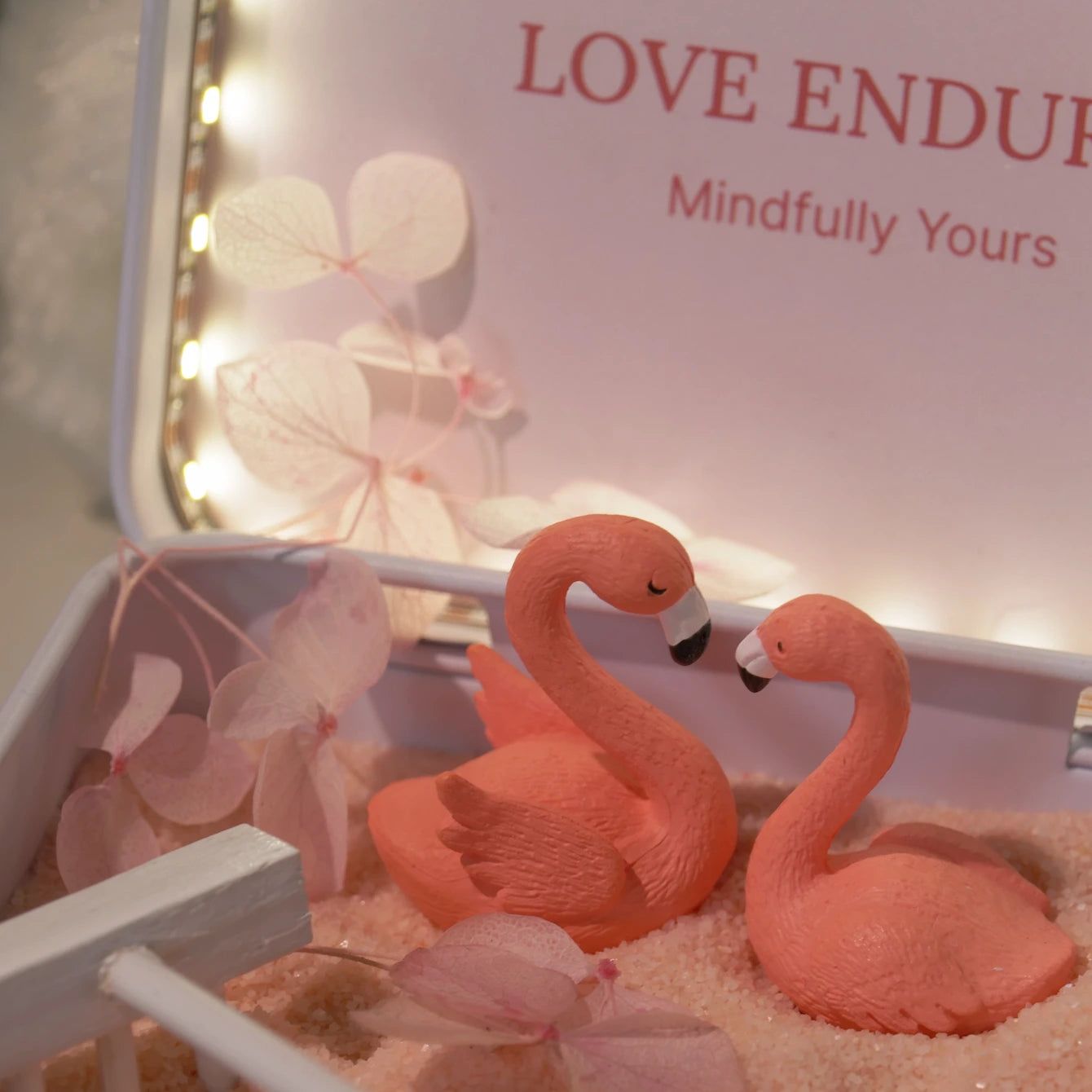 Love Endures Crystal Zen Garden featuring pink flamingos surrounded by soft pink sand and decorative elements.
