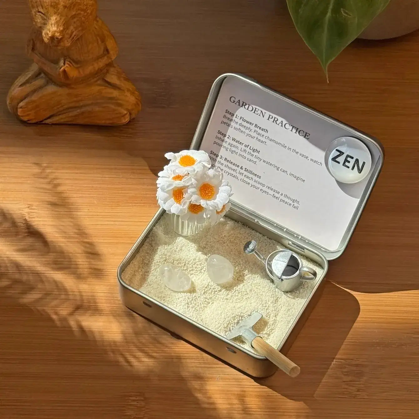 Zenify Blossom Zen Crystal Garden with flowers and tools in a calming setting.