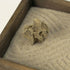 Close-up of a textured natural stone set in raked white sand inside the Japanese Karesansui Zen Garden.
