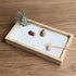 Bamboo desktop Zen Garden with living air plant, coral stones, white sand, and rake