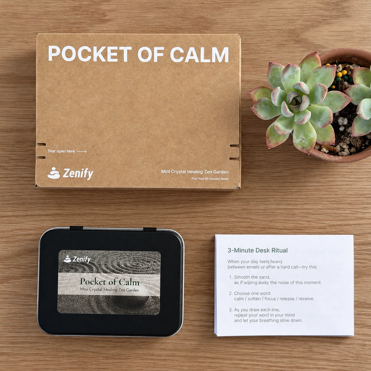 Zenify Pocket of Calm packaging box, closed metal tin and 3-Minute Desk Ritual instruction card on a wooden table.