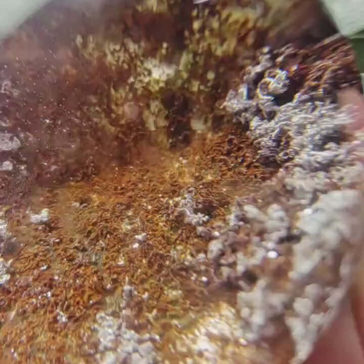 Close-up of Zenify™ Phantom Quartz Sphere, showcasing layered interior and unique phantom formations.