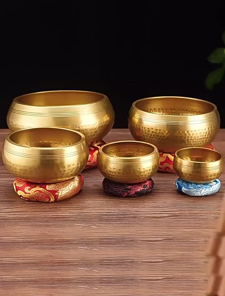 Real singing bowl demonstration showing several bowl sizes and how the wooden striker is used around the rim