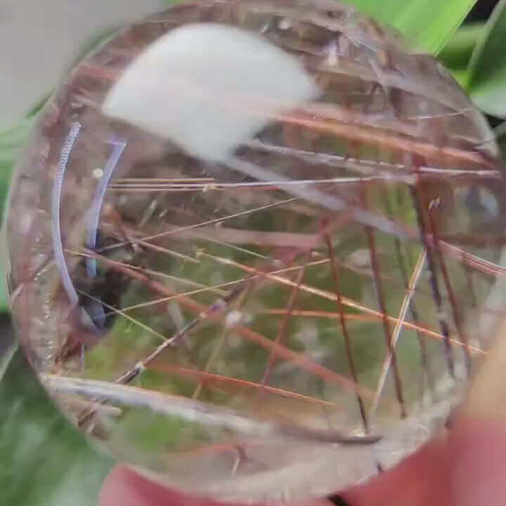 Zenify™ Rutilated Quartz Crystal Sphere showcasing golden rutile threads in a hand for energy flow and clarity.