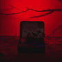 Zenify Halloween Obsidian Pocket Garden in red light, featuring a crystal, mini pumpkins, and a raven.