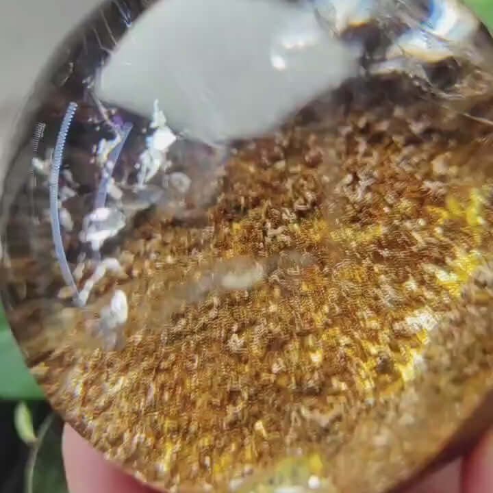 Zenify™ 52mm Phantom Quartz Sphere showcasing a layered interior with a golden hue, perfect for mindfulness and spiritual growth.
