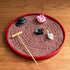 Red swan Zen garden kit with red sand, decorative lotus, stacked stones, and bamboo rake on a wooden surface