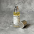 Portable Chakra Aromatherapy Mist for Yoga & Deep Meditation - 10ml bottle on textured gray background.