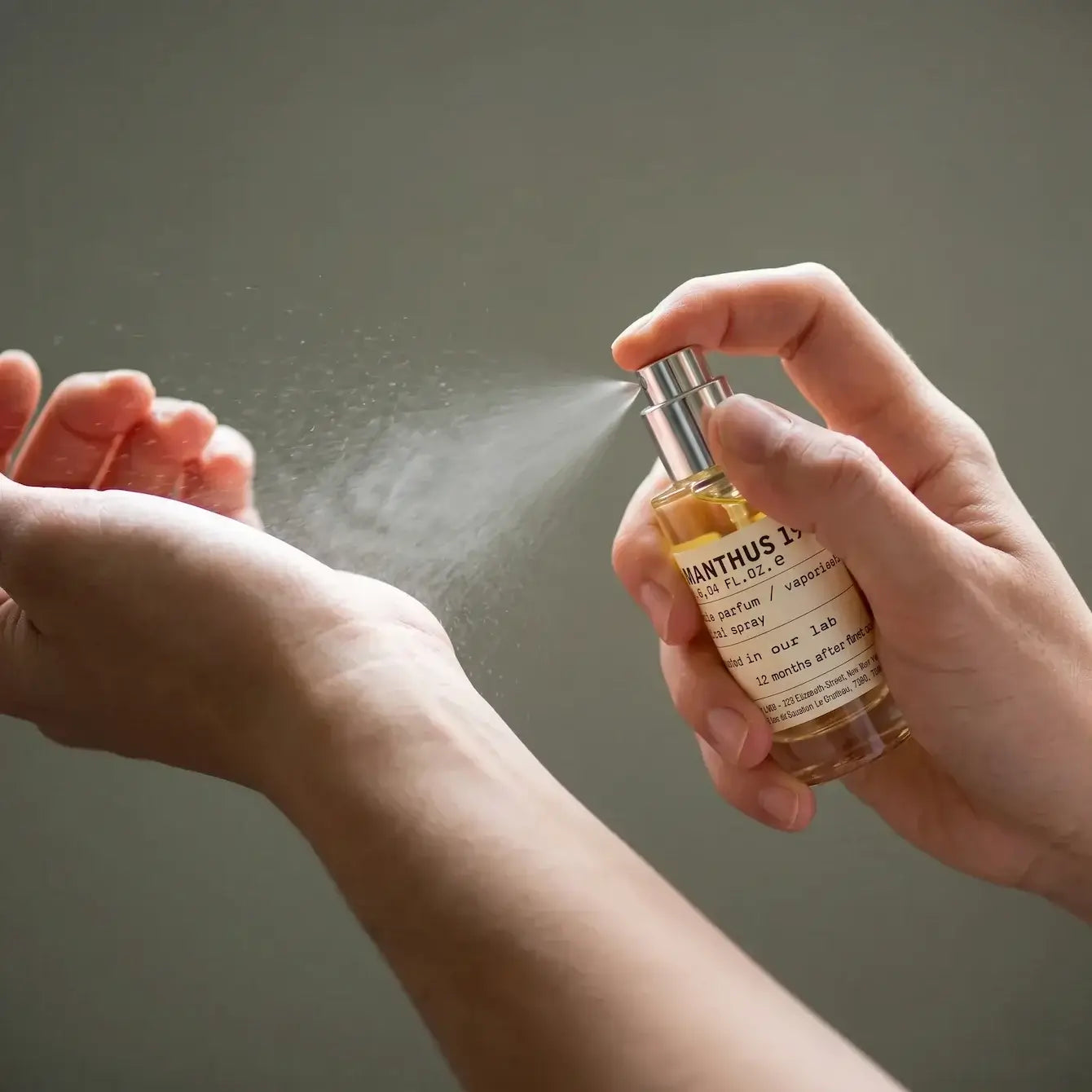 Person using Portable Chakra Aromatherapy Mist for Yoga & Deep Meditation -10ml on wrist for relaxation.