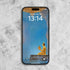 Medicine Buddha phone wallpapers displayed on a smartphone with a serene blue background and golden Buddha image.