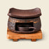 Brown ceramic incense warmer with a curved dish and empty handled candle cup on a square wooden base.